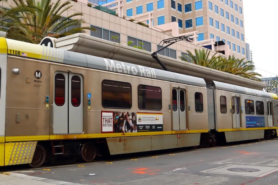 Yellow and silver light rain train in downtown Long Beach, California.